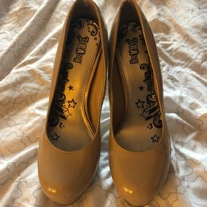 Brash patent leather nude heels